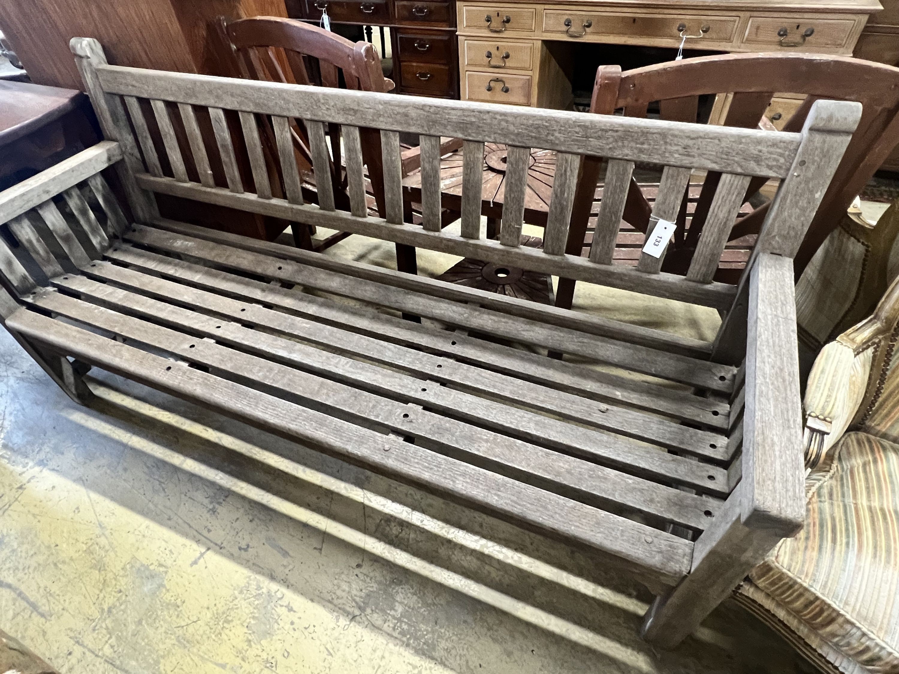 A weathered teak slatted garden bench, width 182cm depth 58cm height 92cm